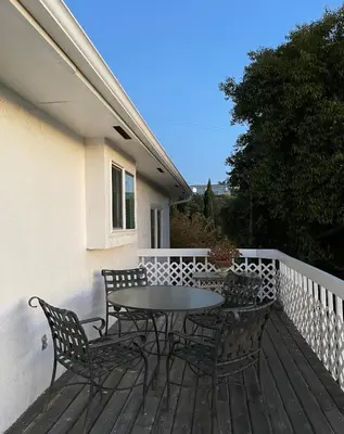 a patio with a table and chairs on a deck at House on Organic Farm in Escondido