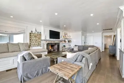 a living room with a couch and a fireplace at Luxury Ocean Views & Steps To The Sand - Tower 36 Lower Condo Unit in Carlsbad