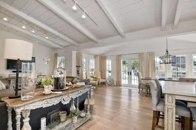 a living room with a fireplace and a dining room at Walk to Beach, AC, Firepit, Grill in Carlsbad