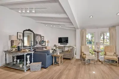 a living room with a blue couch and a mirror at Walk to Beach, AC, Firepit, Grill in Carlsbad