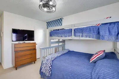 a bedroom with two bunk beds and a television at Oceanfront Escape Steps to Imperial Beach! in Imperial Beach