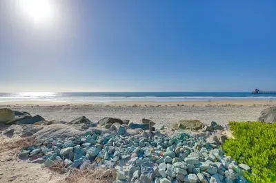 a pile of rocks on a sandy beach at Oceanfront Escape Steps to Imperial Beach! in Imperial Beach