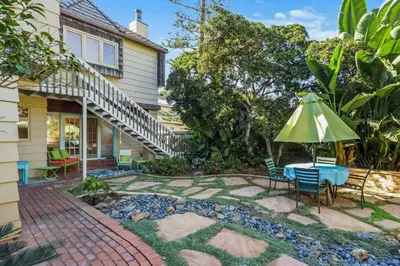 a patio with a table and an umbrella at Oceanview, Walk To Beach, Fire Pit in Carlsbad