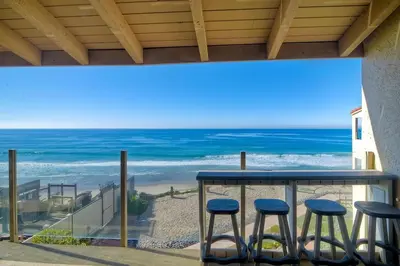 a view of the beach from a balcony with stools at Oceanfront Views, Heated Pool, Hot Tubs, Parking in Solana Beach