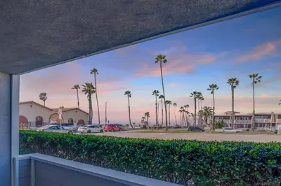 a view from a balcony of a parking lot with palm trees at Sunrise by the Sea 1 Block from Ocean in Oceanside