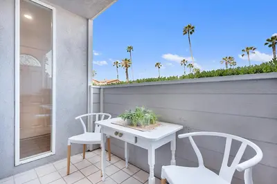 a white table and two chairs on a balcony at Sunrise by the Sea 1 Block from Ocean in Oceanside