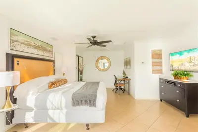 a bedroom with a bed and a ceiling fan at Villa Inn- Adult Only- Temecula Wine Country in Temecula