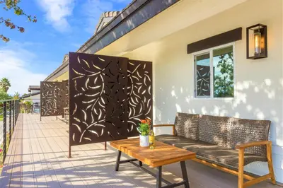 a screened in porch with a bench and a table at Villa Inn- Adult Only- Temecula Wine Country in Temecula
