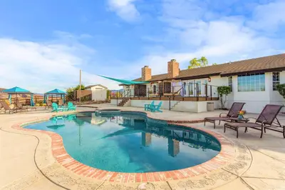 a swimming pool with chairs and a building at Villa Inn- Adult Only- Temecula Wine Country in Temecula