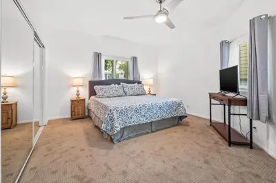a bedroom with a bed and a flat screen tv at Life on the Point in San Diego