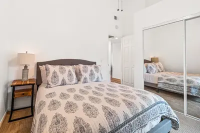 a bedroom with a bed and a mirror at Life on the Point in San Diego