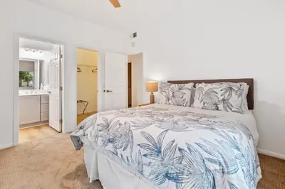 a bedroom with a bed with a blue and white bedspread at Life on the Point in San Diego