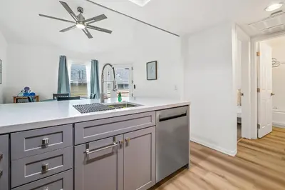 a kitchen with a sink and a ceiling fan at Life on the Point in San Diego