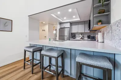 a kitchen with a large counter with two stools at Life on the Point in San Diego