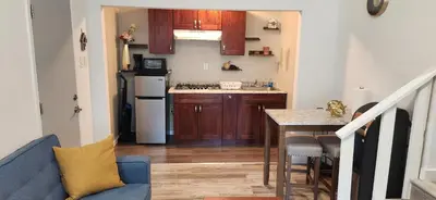 a small kitchen with a blue couch and a table at New ! Lovely Studio w/ patio, Parking on premises in Escondido