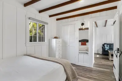 a white bedroom with a bed and a window at Charming Hillcrest/Mission Hills 3 BR + House in San Diego