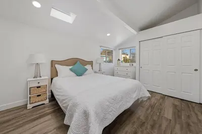 a white bedroom with a large bed and a window at Charming Hillcrest/Mission Hills 3 BR + House in San Diego