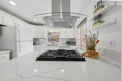 a kitchen with white cabinets and a stove top oven at Charming Hillcrest/Mission Hills 3 BR + House in San Diego