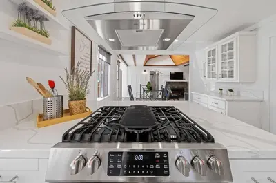 a kitchen with a stove top in a white kitchen at Charming Hillcrest/Mission Hills 3 BR + House in San Diego