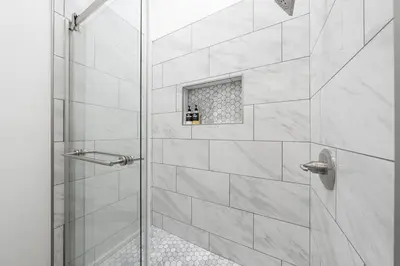 a bathroom with a shower with a glass door at Charming Hillcrest/Mission Hills 3 BR + House in San Diego
