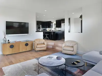 a living room with a couch and a tv at Grandview Getaway, Luxury 4BR, Ocean View, Fire Pit in Encinitas