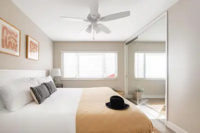 a bedroom with a bed with a hat on it at Seashore Suites by AvantStay in San Diego