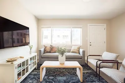a living room with a couch and a tv at Seashore Suites by AvantStay in San Diego