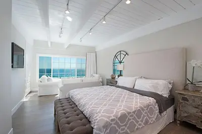 a bedroom with a large bed and a large window at Expansive Ocean View, Private Balcony, Across from Beach in Carlsbad