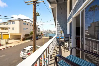 a balcony of a house with a car on the street at Walk on the Ocean! Wake up to Beautiful Bay Views in Newport Beach