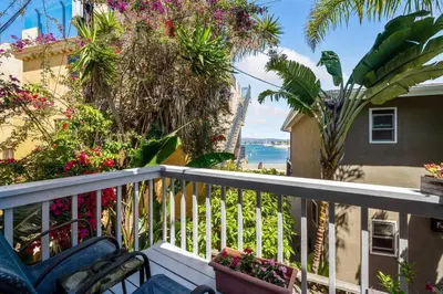 a balcony with a view of the ocean at Walk on the Ocean! Wake up to Beautiful Bay Views in Newport Beach