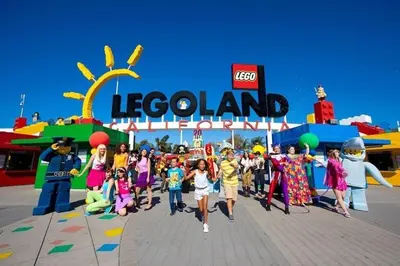 a group of children walking in front of a legoland amusement park at Ocean View From Private Patio, Across Street From Beach in Carlsbad