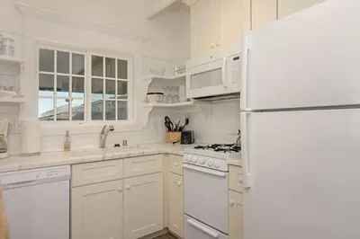 a kitchen with white appliances and a white refrigerator at Ocean View From Private Patio, Steps To Beach, Parking in Carlsbad