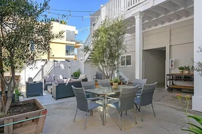 a patio with a glass table and chairs at Ocean View From Private Patio, Steps To Beach, Parking in Carlsbad