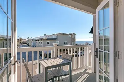 a balcony with a table and a view of the ocean at Ocean View From Private Patio, Steps To Beach, Parking in Carlsbad