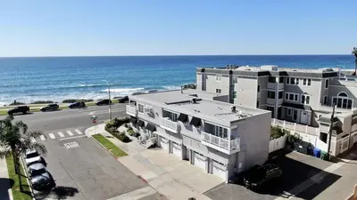 an aerial view of a building next to the ocean at Ocean View From Private Patio, Steps To Beach, Parking in Carlsbad