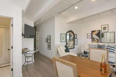 a dining room and living room with a table at Ocean View From Private Patio, Steps To Beach, Parking in Carlsbad