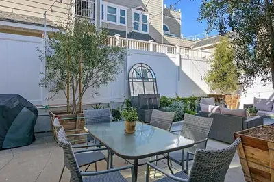 a patio with a table and chairs and a fence at Ocean View From Private Patio, Steps To Beach, Parking in Carlsbad