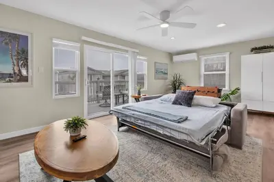 a bedroom with a bed and a table and a couch at Tower 9 #1 in Oceanside