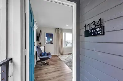 a door leading into a room with a chair at Tower 9 #2 in Oceanside