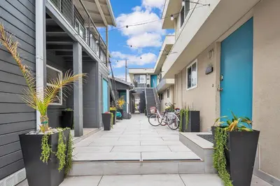 a walkway between two buildings with bikes parked on it at Tower 9 #2 in Oceanside