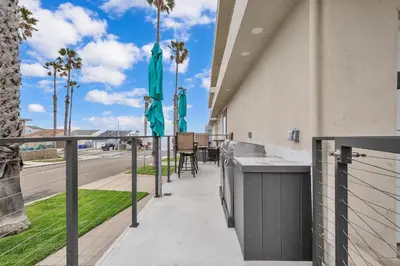 a balcony with a bar and palm trees and a street at Tower 9 #2 in Oceanside