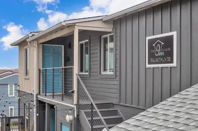 a house with a blue door and stairs on it at Tower 9 #2 in Oceanside