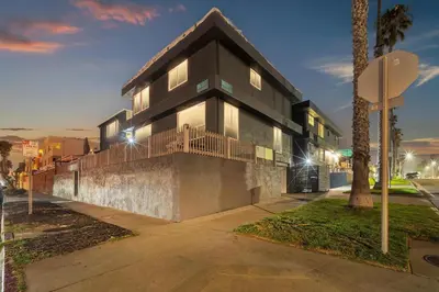 a black building with a balcony on a street at Tower 9 #4 in Oceanside