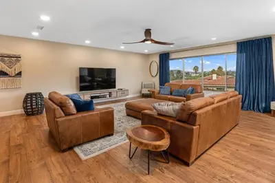 a living room with leather furniture and a flat screen tv at Designer 4 BR La Mesa Home w/ Yard and BBQ in La Mesa