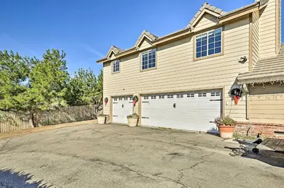 a house with two garage doors in a driveway at Garden, Gazebo and Fire Pit Fallbrook Home! in Fallbrook