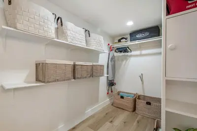 a walk in closet with baskets and shelves at Ritz Pointe Paradise! in Dana Point