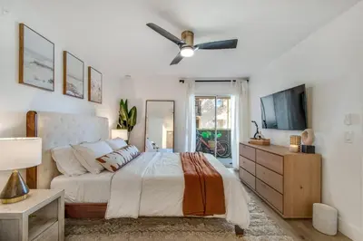 a bedroom with a bed and a ceiling fan at Ritz Pointe Paradise! in Dana Point