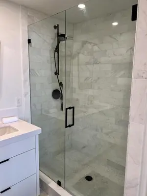 a shower with a glass door in a bathroom at Oceanfront Fully Remodeled 2BR 2BA, Pool, Hot Tub, Gated Parking in Solana Beach