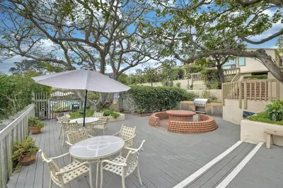 a patio with a table and chairs and an umbrella at Oceanfront Fully Remodeled 2BR 2BA, Pool, Hot Tub, Gated Parking in Solana Beach
