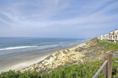 a view of a beach with buildings and the ocean at Oceanfront Fully Remodeled 2BR 2BA, Pool, Hot Tub, Gated Parking in Solana Beach